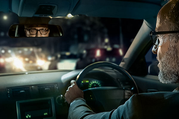 man driving at night